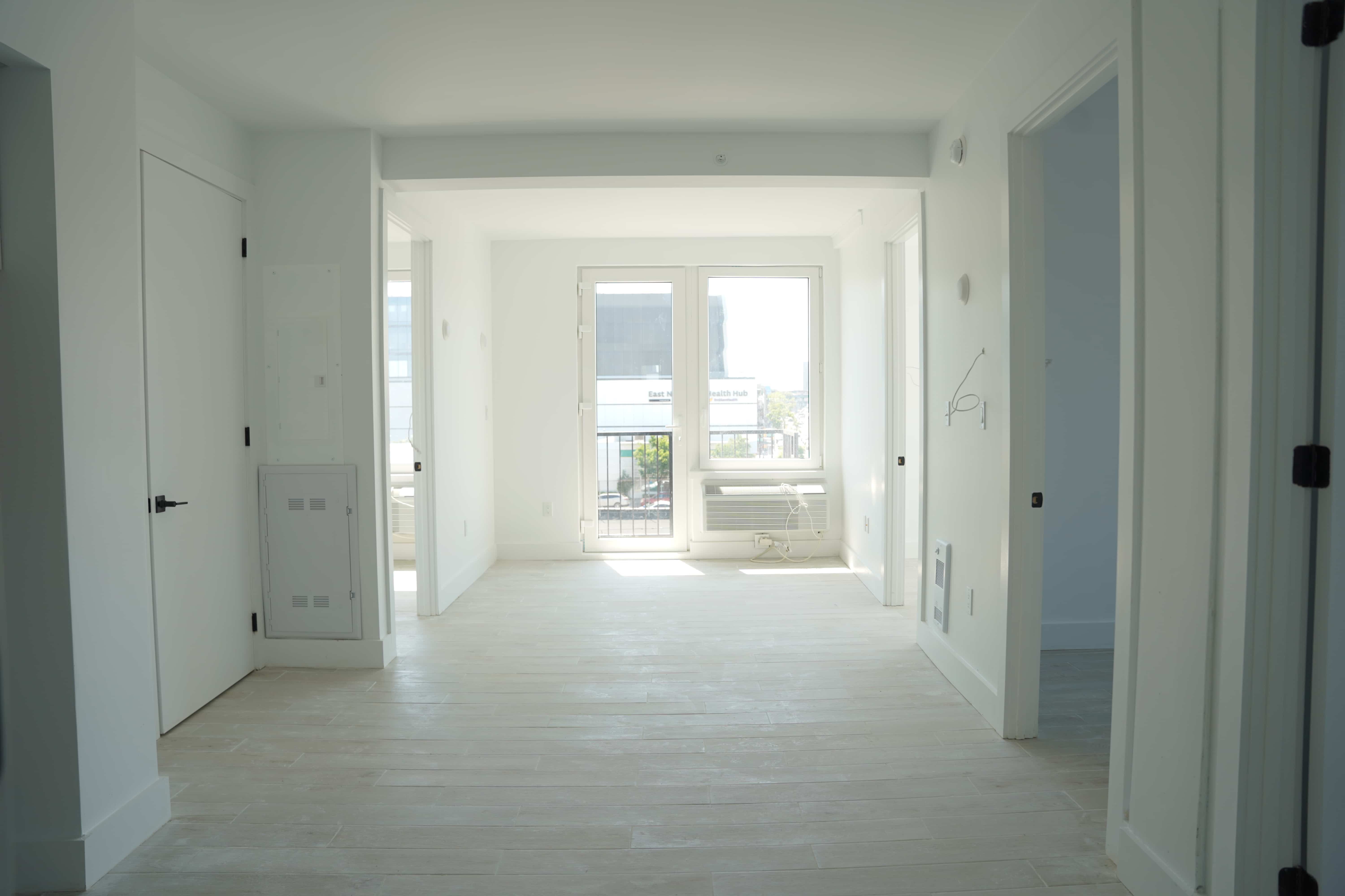 apartment with pale floors, door to terrace