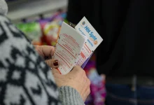 Hawthorne, CA - December 1: Ellen Adelman waits in line with her lottery tickets at Bluebird Liquor on Monday, Dec. 1, 2025 in Hawthorne, CA. Adelman and her husband William have been playing the lottery at Bluebird Liquor for years.  (Juliana Yamada / Los Angeles Times via Getty Images)
