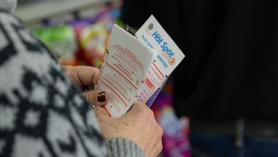 Hawthorne, CA - December 1: Ellen Adelman waits in line with her lottery tickets at Bluebird Liquor on Monday, Dec. 1, 2025 in Hawthorne, CA. Adelman and her husband William have been playing the lottery at Bluebird Liquor for years.  (Juliana Yamada / Los Angeles Times via Getty Images)