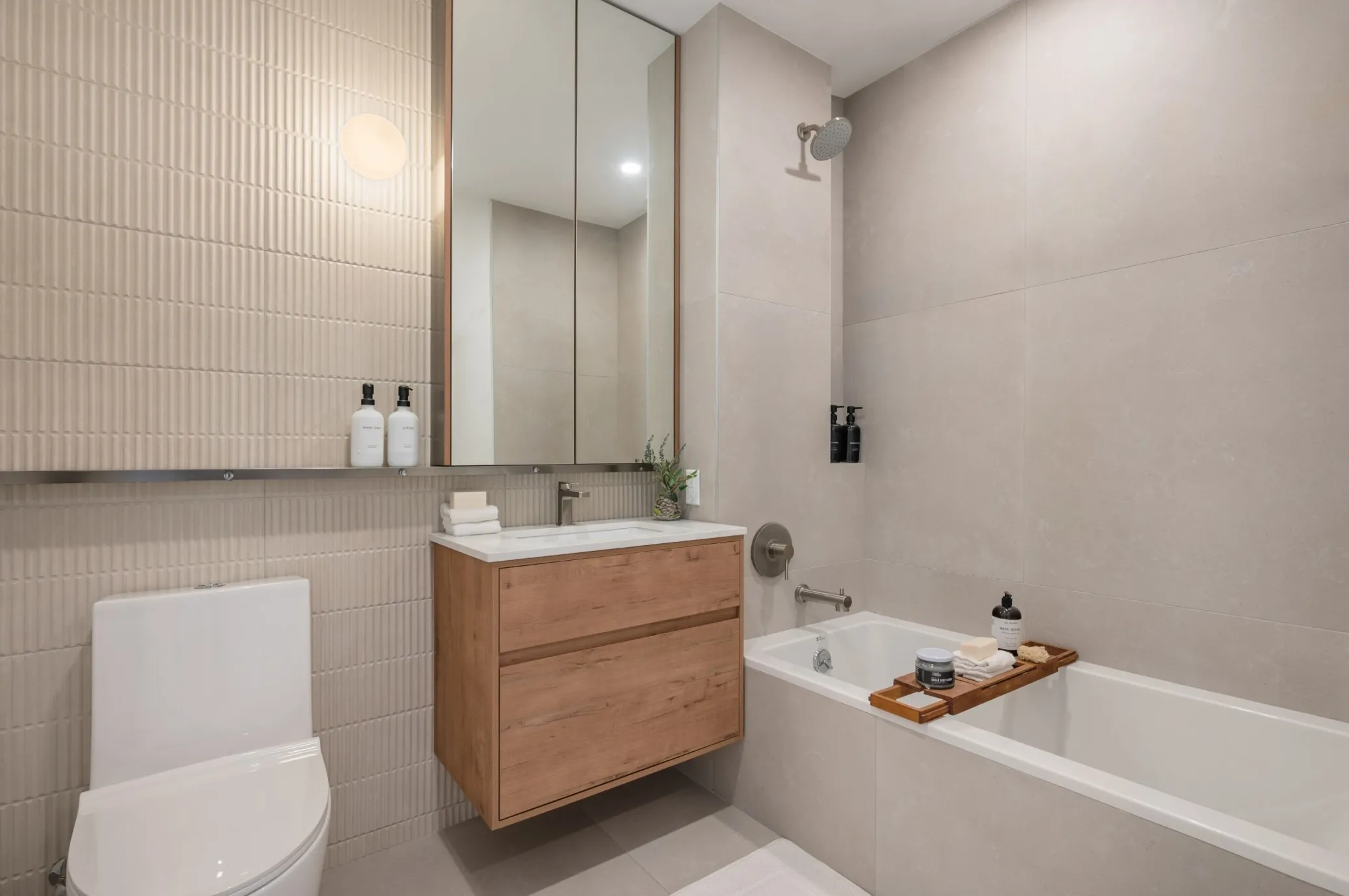 bathroom with floating vanity, beige tile