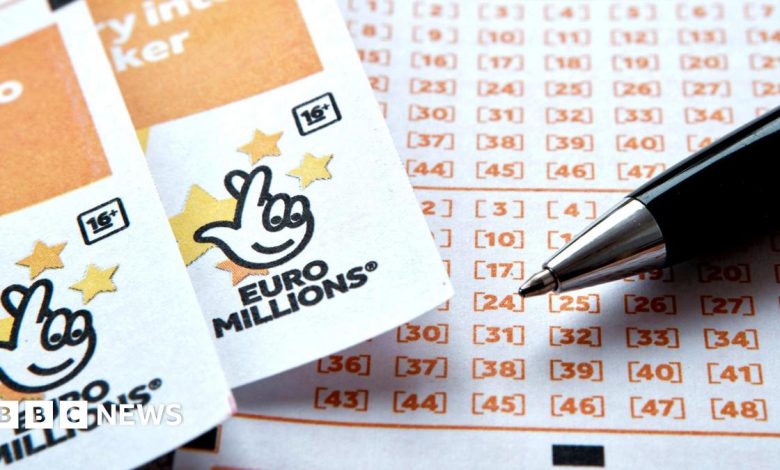 Two EuroMillions tickets side-by-side, with the National Lottery logo seen at the top of both, beside a ballpoint pen