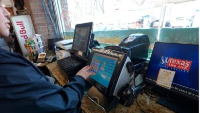 Edith Patlan uses a Texas Lottery terminal to complete at purchase of lottery tickets at Fuel City in Dallas, Wednesday, Feb. 26, 2025. (AP Photo/LM Otero)