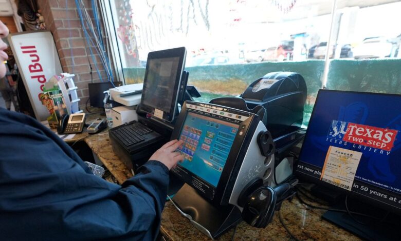 Edith Patlan uses a Texas Lottery terminal to complete at purchase of lottery tickets at Fuel City in Dallas, Wednesday, Feb. 26, 2025. (AP Photo/LM Otero)