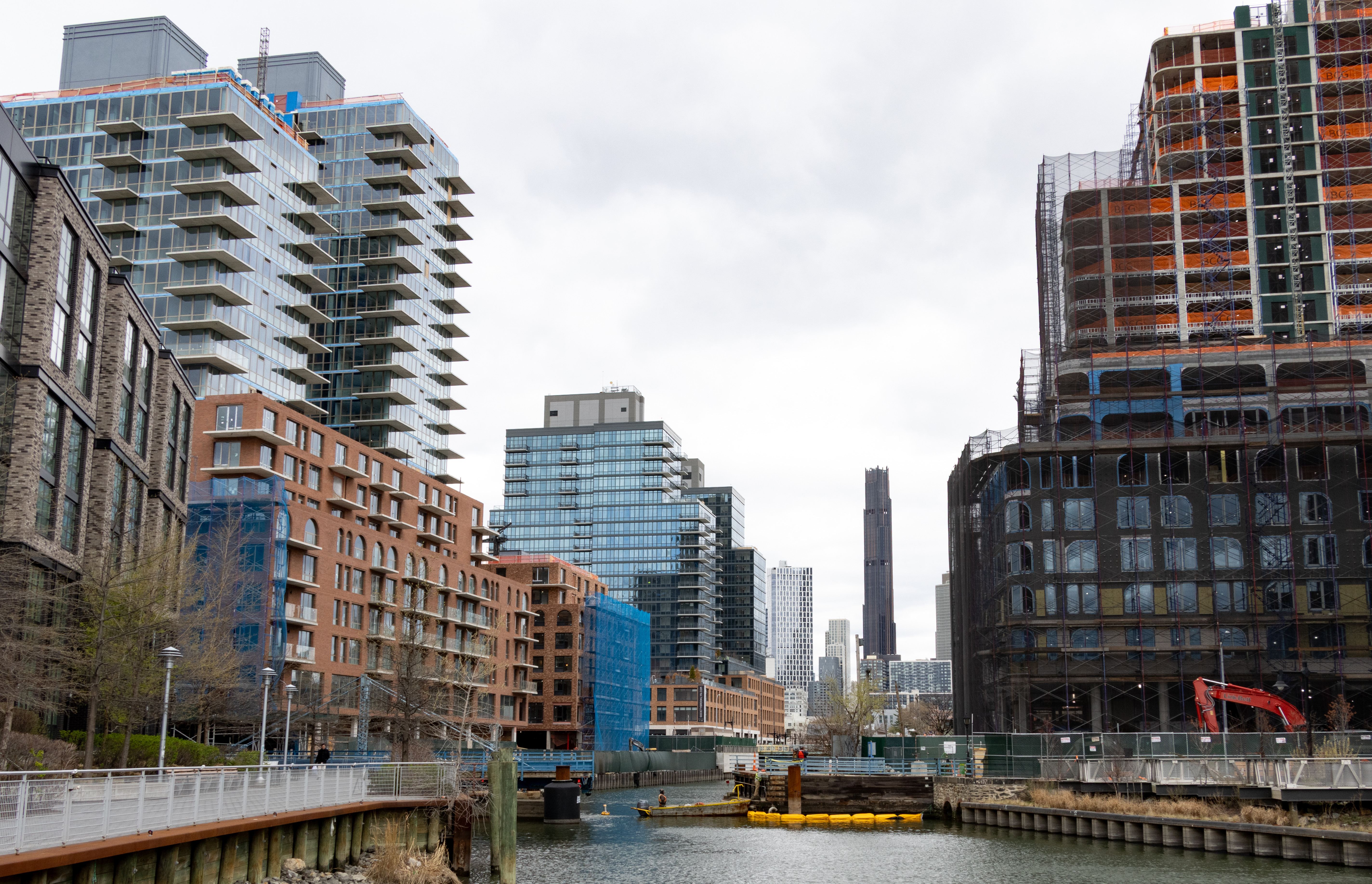 view along gowanus canal with buildings under construction