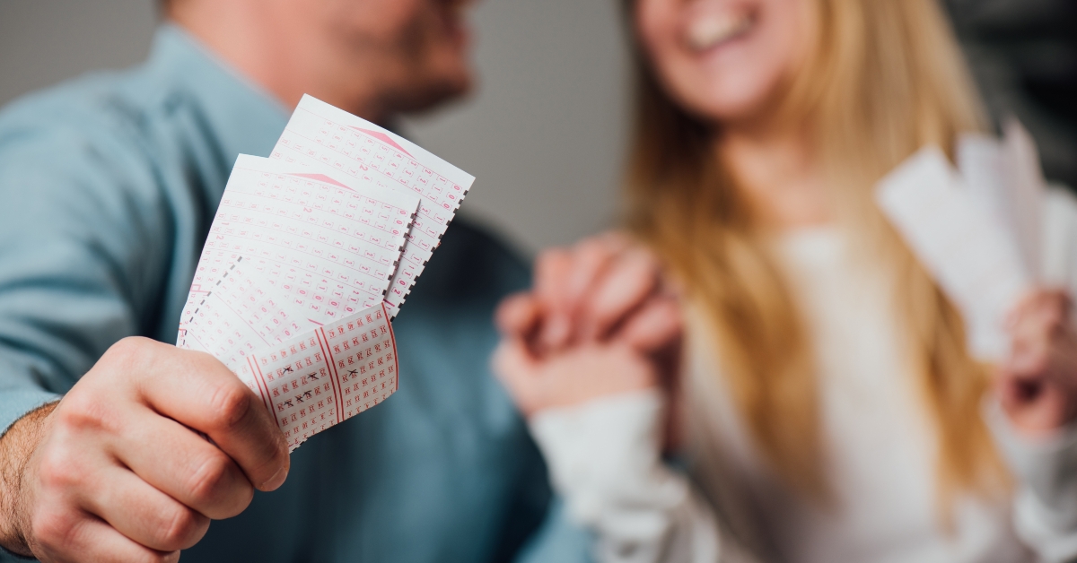 couple holding lottery tickets