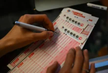 A person plays lottery at a store as US Powerball jackpot grand prize grew to a whopping $1 billion after no ticket got all six numbers in San Mateo, California - Source: Getty