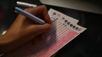 A person plays lottery at a store as US Powerball jackpot grand prize grew to a whopping $1 billion after no ticket got all six numbers in San Mateo, California - Source: Getty