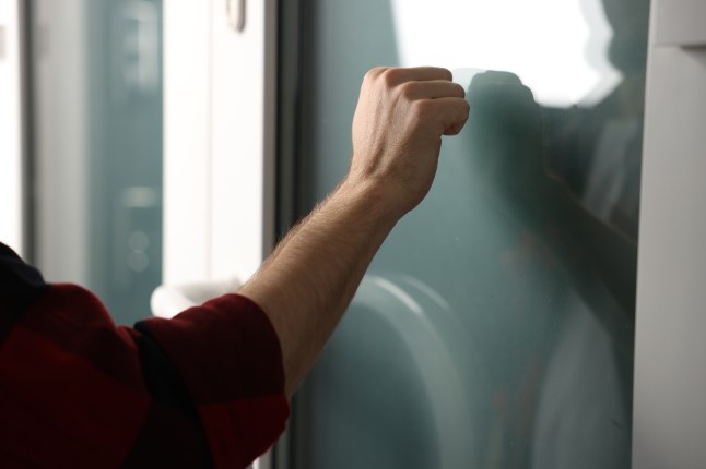 Man knocking on apartment door, closeup view