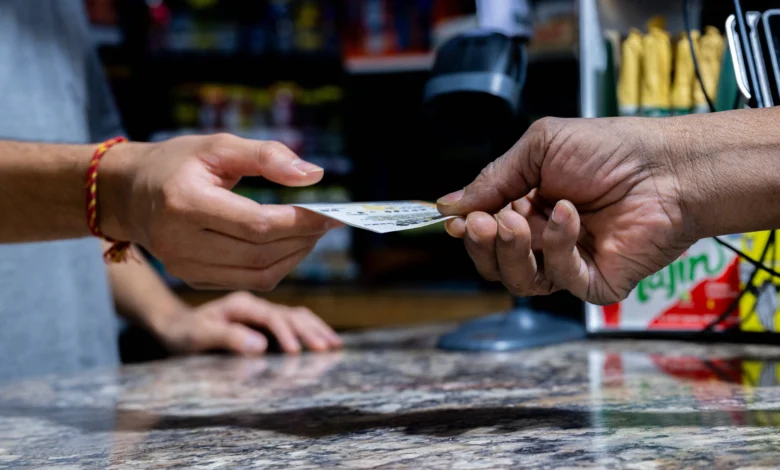 AUSTIN, TEXAS - OCTOBER 10: A customer purchases a Powerball lottery ticket at the Brew Market &amp; Cafe on October 10, 2023 in Austin, Texas. The Powerball jackpot has grown to over $1.7 billion, making it the second largest jackpot in history. (Photo by Brandon Bell/Getty Images)