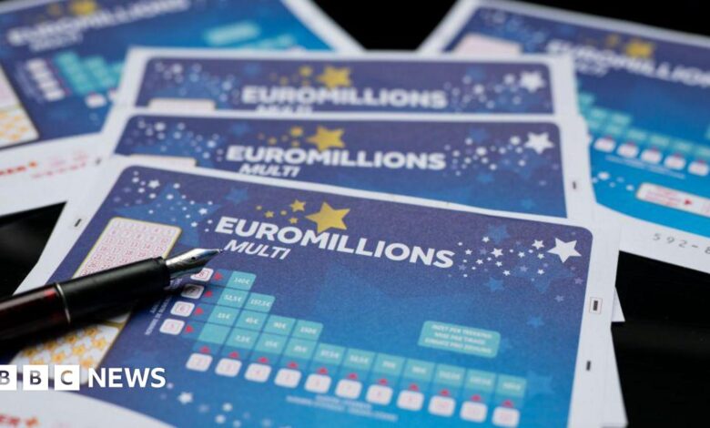 A Euromillions paper ticket with a pen on top.