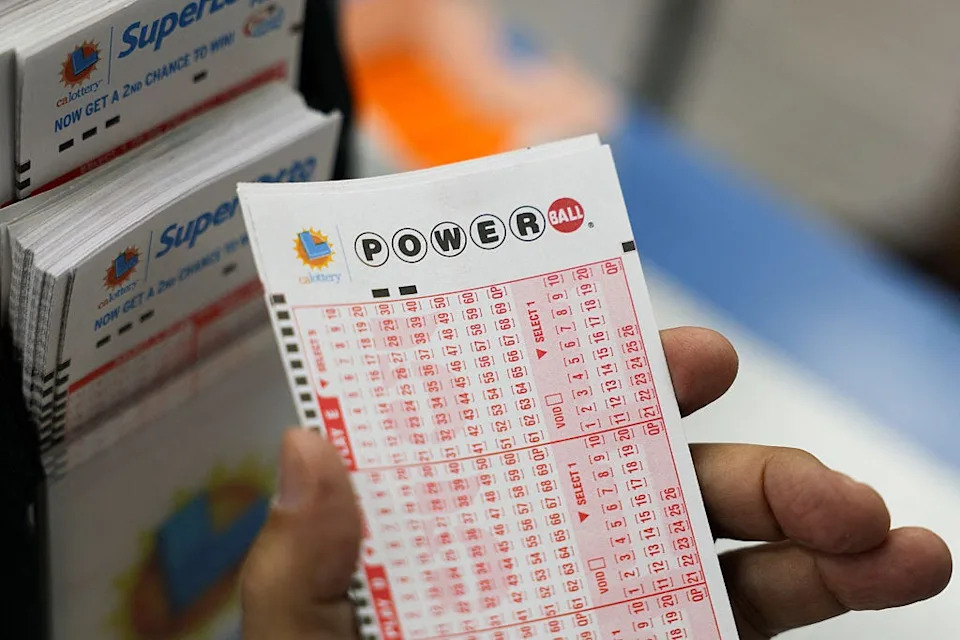 A customer holds a number slip for Powerball lottery tickets in Hawthorne, California on August 25, 2025.