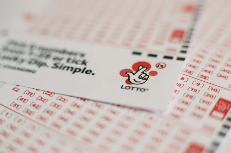 A close-up of a National Lottery Lotto slip with the Lotto logo.