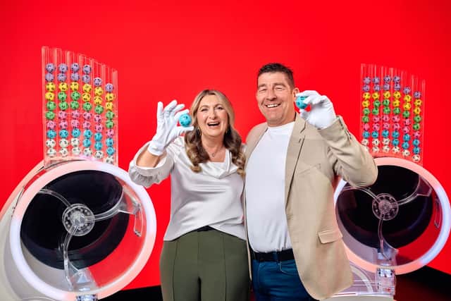 Chris and Geraldine Bradley, who won £3.57M on Lotto in 2006, alongside the two Lotto draw machines to mark the new two-round format