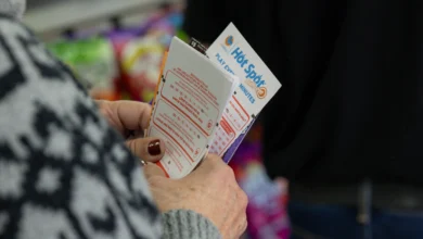 Hawthorne, CA - December 1: Ellen Adelman waits in line with her lottery tickets at Bluebird Liquor on Monday, Dec. 1, 2025 in Hawthorne, CA. Adelman and her husband William have been playing the lottery at Bluebird Liquor for years.  (Juliana Yamada / Los Angeles Times via Getty Images)