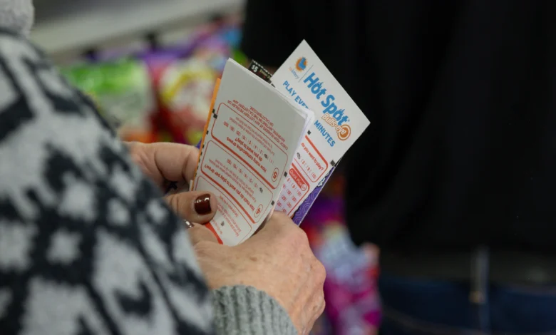 Hawthorne, CA - December 1: Ellen Adelman waits in line with her lottery tickets at Bluebird Liquor on Monday, Dec. 1, 2025 in Hawthorne, CA. Adelman and her husband William have been playing the lottery at Bluebird Liquor for years. (Juliana Yamada / Los Angeles Times via Getty Images)