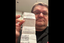 robert gawlitza holds up a lottery ticket