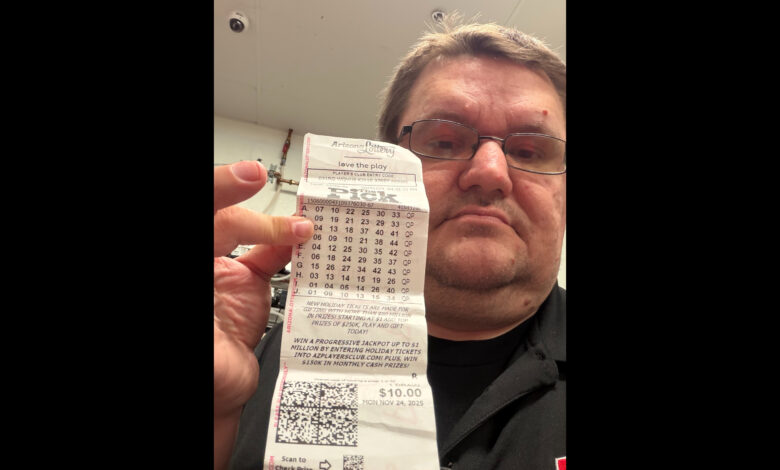 robert gawlitza holds up a lottery ticket