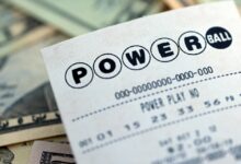 A picture of a Powerball lottery ticket on top of money