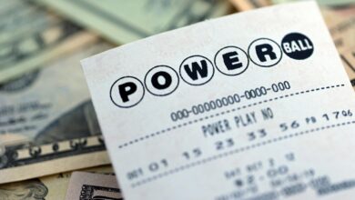 A picture of a Powerball lottery ticket on top of money