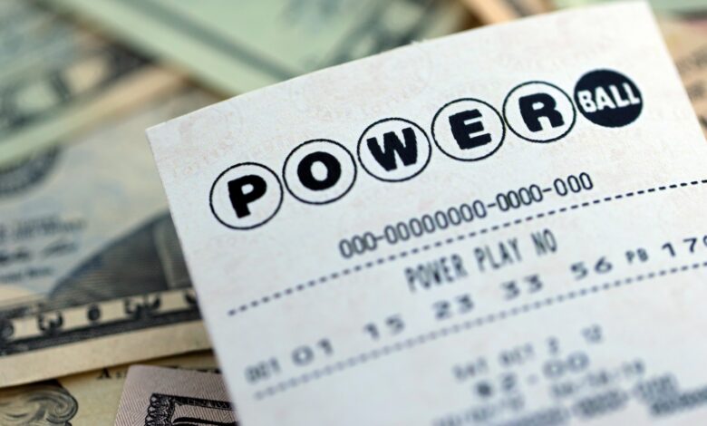 A picture of a Powerball lottery ticket on top of money