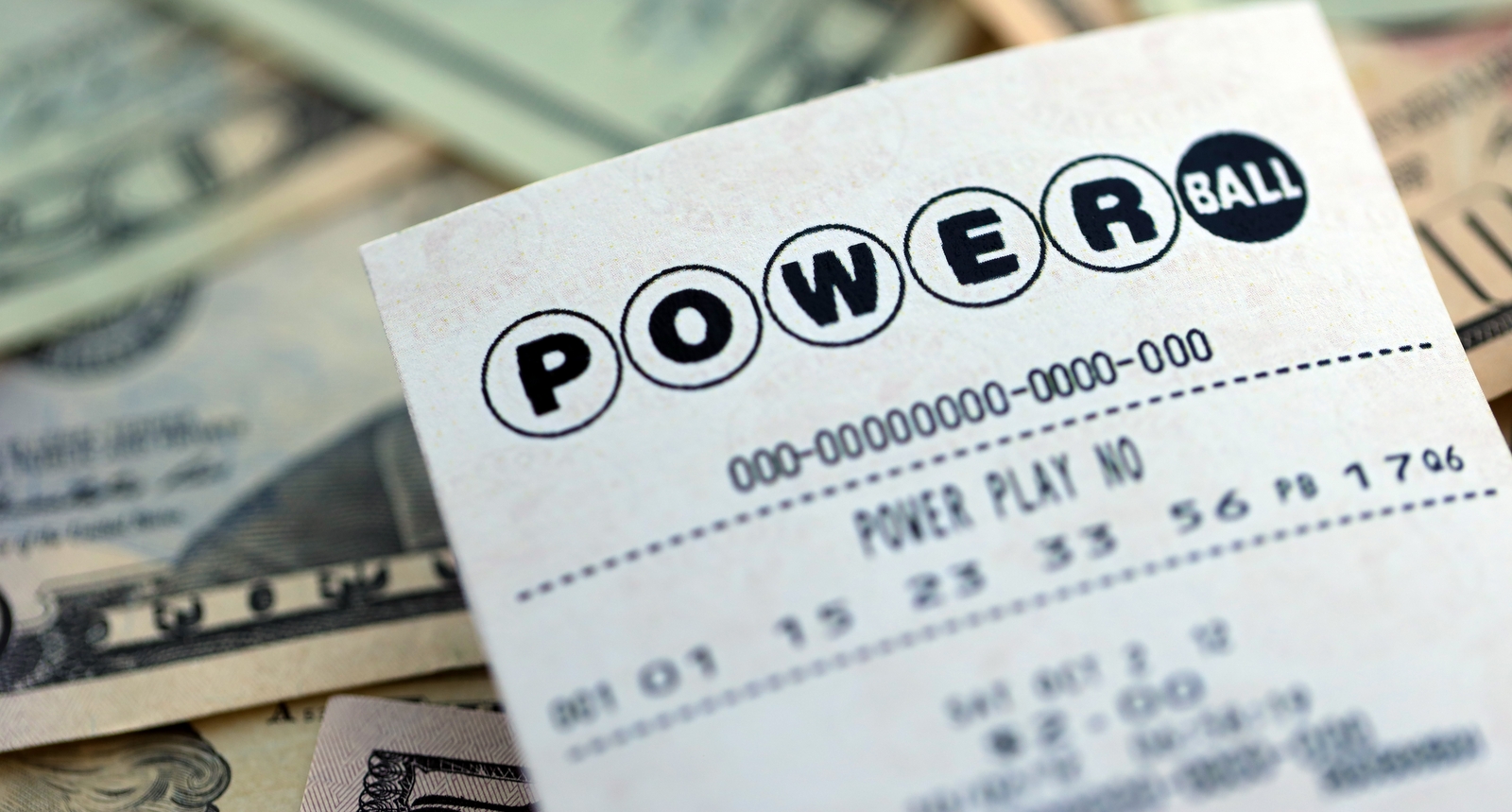 A picture of a Powerball lottery ticket on top of money