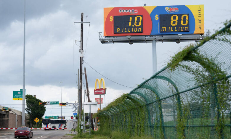 A billboard displays the estimated Powerball jackpot in Houston, Tuesday, Aug. 11, 2026. (AP Ph ...