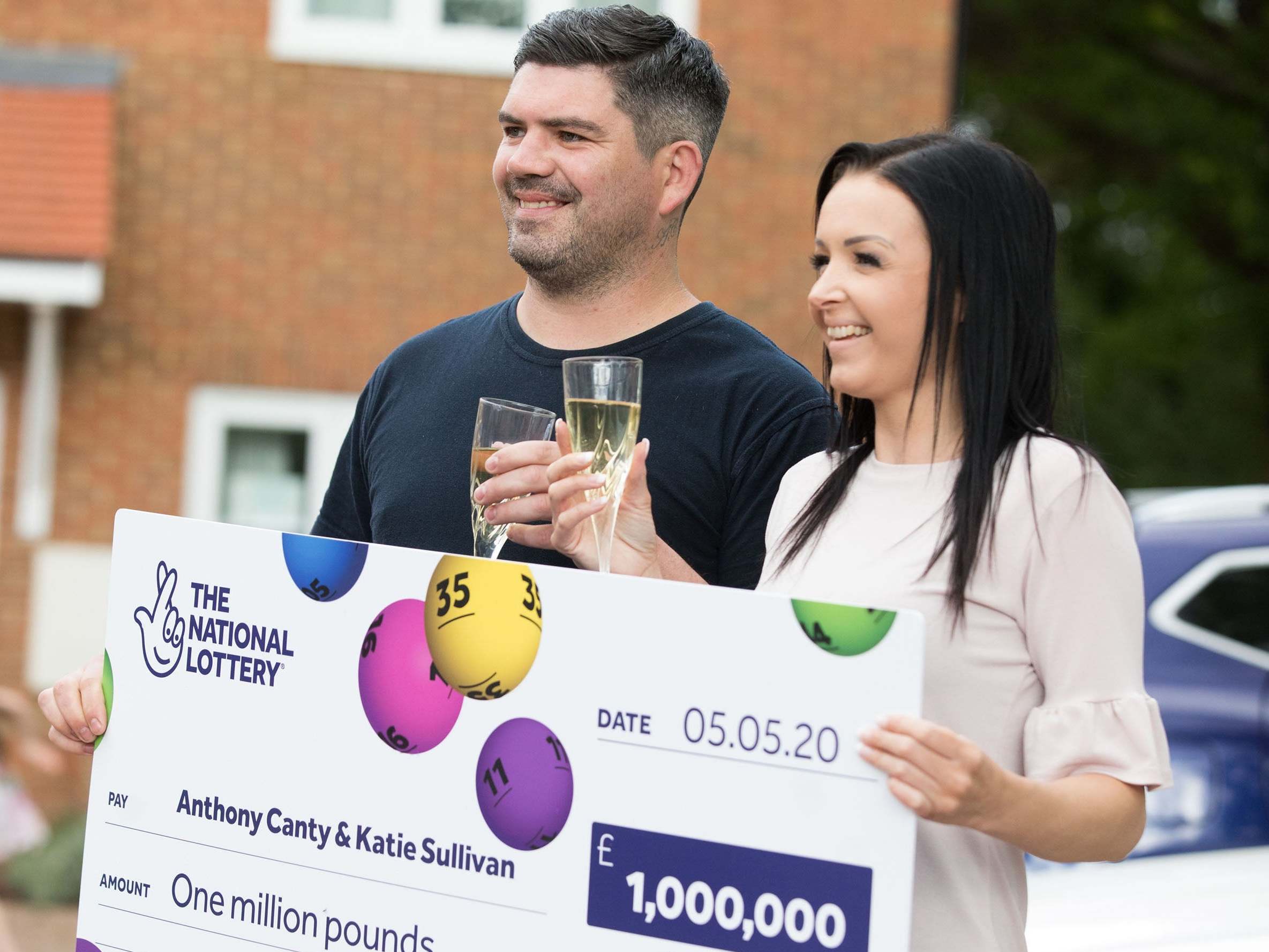 Anthony Canty, 33, from Maldon in Essex, who won £1 million in the Euromillions UK Millionaire Maker draw, celebrating with his partner Katie