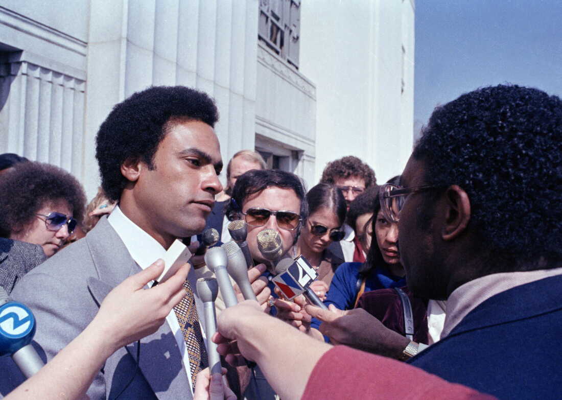 In this March 7, 1979 file photo, former Black Panther leader Huey Newton speaks to reporters outside the courthouse in Oakland, Calif.