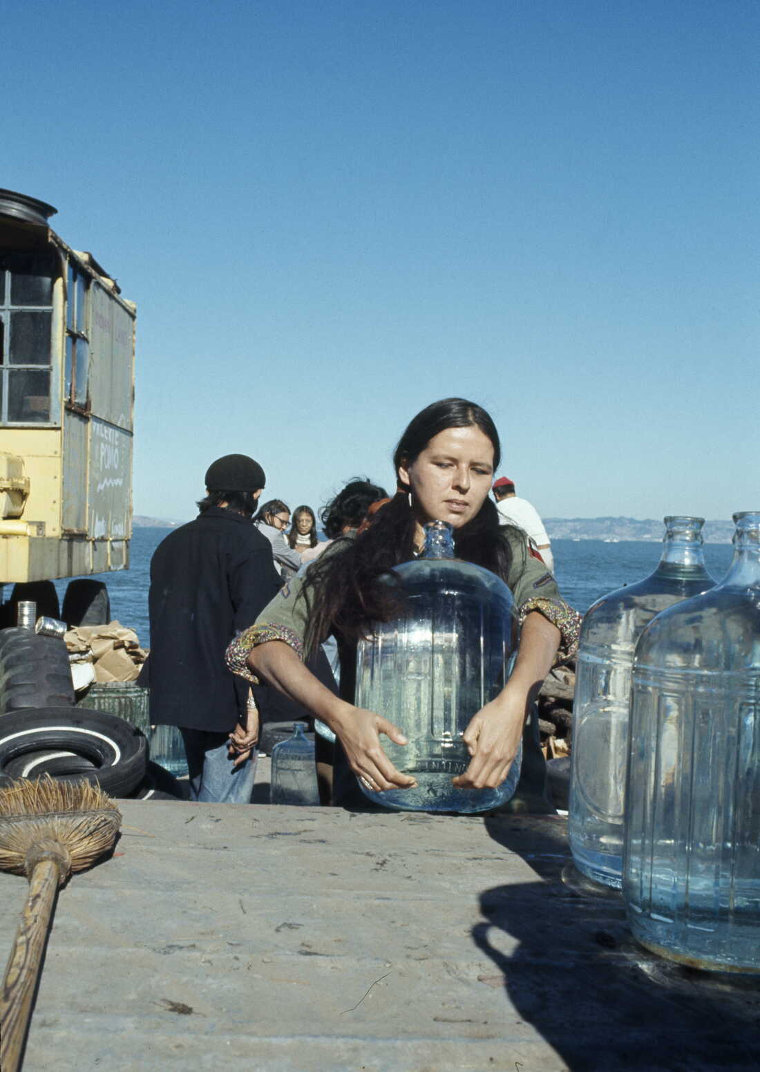A young woman sets up large bottles of drinking water on Alcatraz Island on Nov. 17, 1970. This was part of a 19-month-long occupation by Native American activists in protest of U.S. government policies on treaties.
