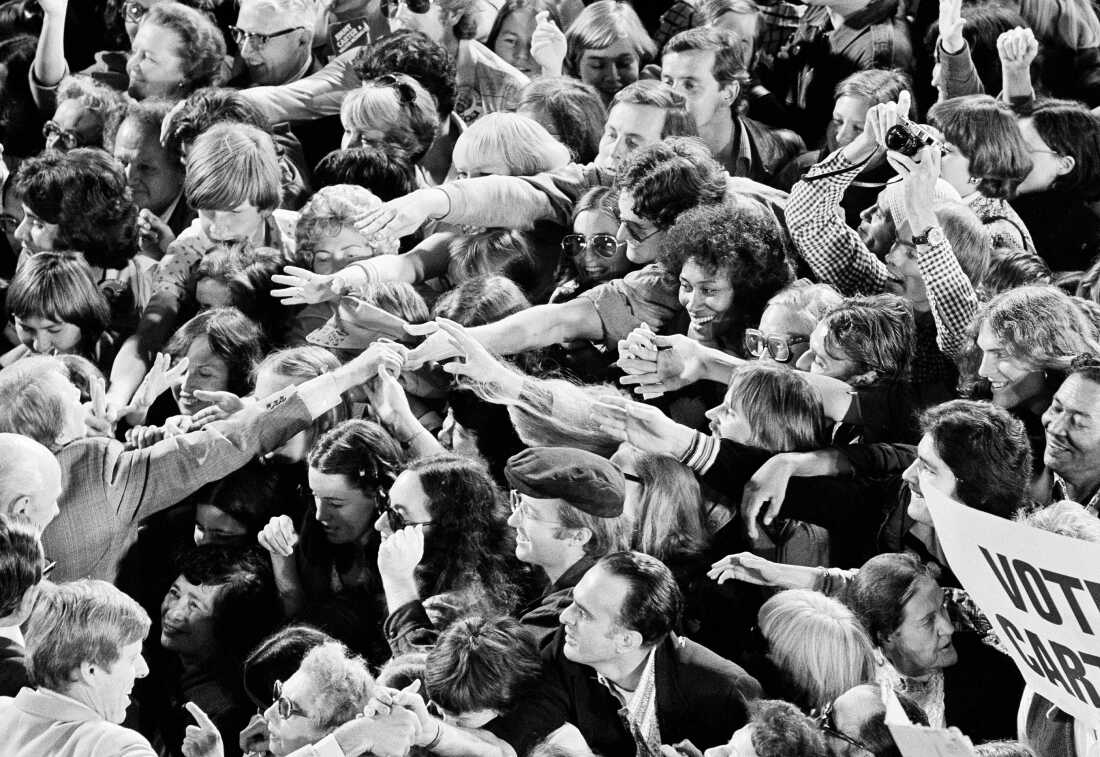 A crowd surges forward as Jimmy Carter shakes hands following a political rally in San Francisco on Oct. 31, 1976.