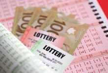 Lottery tickets lies with canadian dollars on gambling sheets with numbers for marking to play lottery. Lottery playing concept or gambling addiction