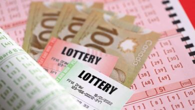 Lottery tickets lies with canadian dollars on gambling sheets with numbers for marking to play lottery. Lottery playing concept or gambling addiction