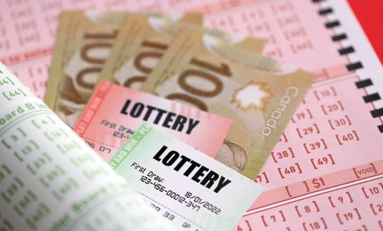 Lottery tickets lies with canadian dollars on gambling sheets with numbers for marking to play lottery. Lottery playing concept or gambling addiction