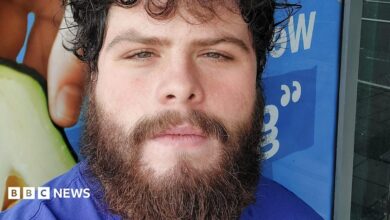 Photo of Jake Davison. He has curly dark hair and a brown bushy beard. He is looking into the camera.