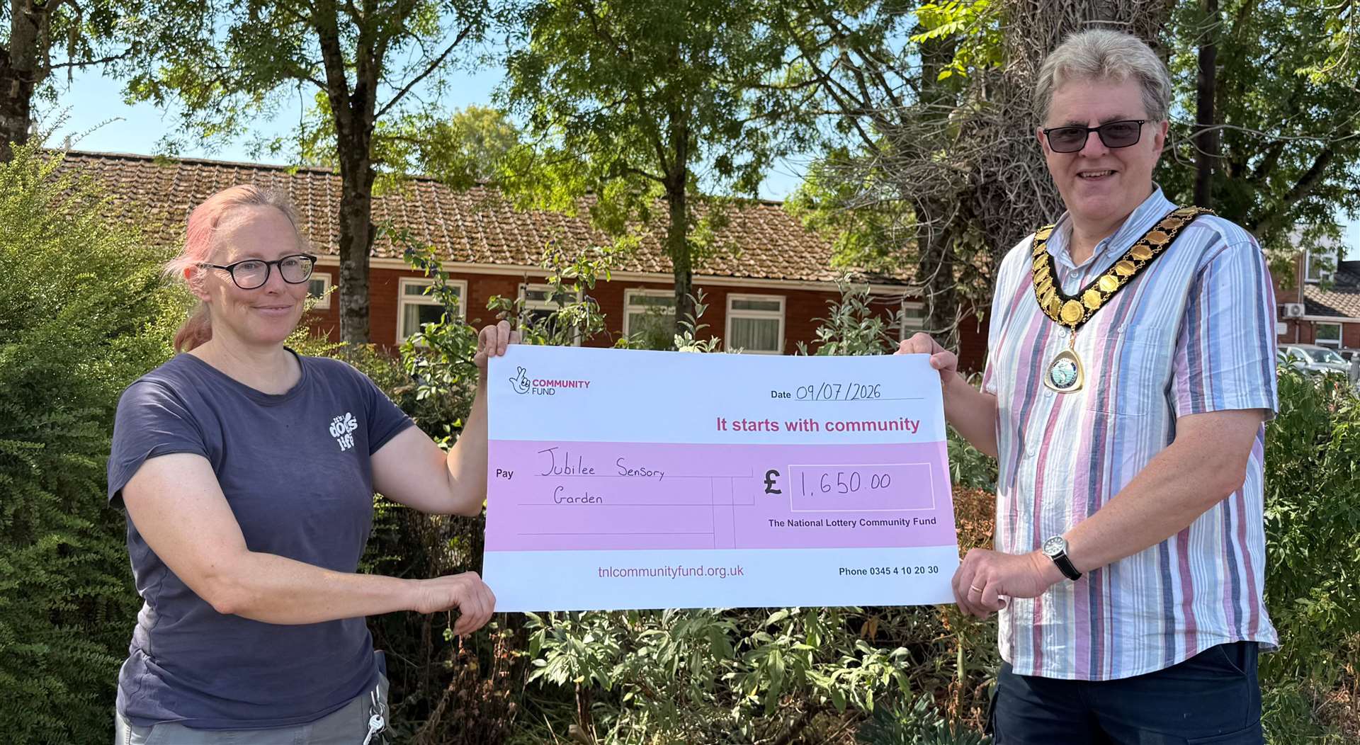 National Lottery cheque presentation with mayor and councillor Mark Lillycrop and Gardener, Polly Pereia.