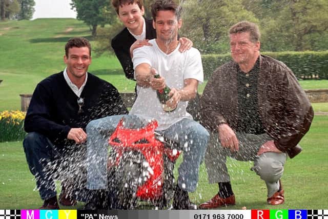 Twenty three-year-old Karl Crompton sprays the bubbly around after he collected his National Lottery win of £10,903,198 at Moor Park Golf Club in Rickmansworth this afternoon (Tuesday), along with his parents Patricia and Keith (right), and brother Sean (left).